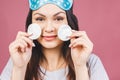 Healthy fresh girl removing makeup from her face with cotton pad. Beauty woman cleaning her face with cotton swab pad isolated on Royalty Free Stock Photo