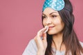 Healthy fresh girl removing makeup from her face with cotton pad. Beauty woman cleaning her face with cotton swab pad isolated on Royalty Free Stock Photo