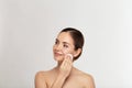 Healthy fresh girl removing makeup from her face with cotton pad. Beauty woman cleaning her face with cotton swab pad isolated on Royalty Free Stock Photo