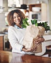 Healthy, fresh and organic vegetables in a shopping bag at home with a happy black woman in a kitchen. Portrait of Royalty Free Stock Photo