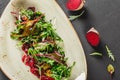 Healthy fresh salad with baked beets, greens, arugula, spinach and croutons in plate over dark table. Healthy vegan food, Royalty Free Stock Photo