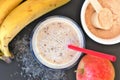 Healthy fresh smoothie drink from red apple, banana chia seeds and plant protein powder in the glass with straw Royalty Free Stock Photo