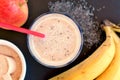 Healthy fresh smoothie drink from red apple, banana chia seeds and plant protein powder in the glass with straw Royalty Free Stock Photo