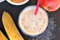 Healthy fresh smoothie drink from red apple, banana chia seeds and plant protein powder in the glass with straw Royalty Free Stock Photo