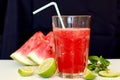 Healthy fresh smoothie drink from red watermelon, lime, mint and ice drift