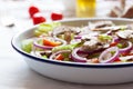 Healthy fresh summer salad with letucce, radish, cherry tomatoes, red onion and champignons with italian herbs on a table Royalty Free Stock Photo