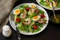 Healthy fresh vegetable salad with shrimps, boiled eggs and avocado