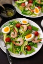 Healthy fresh vegetable salad with shrimps, boiled eggs and avocado