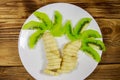 Healthy fruit dessert for children of kiwi and bananas in the shape of a palm tree