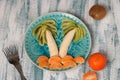 Healthy fruit salad for children of kiwi, bananas and tangerines Royalty Free Stock Photo