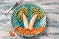 Healthy fruit salad for children of kiwi, bananas and tangerines Royalty Free Stock Photo