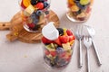 Fruit salad served in individual cups with banana, pineapples, berries, orange dressing and mint Royalty Free Stock Photo