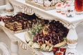 Healthy fruit snacks at wedding reception, grapes, pears, and oranges near cakes at candy bar close-up, luxury restaurant dessert Royalty Free Stock Photo