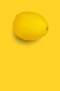 Juicy and ripe lemon on yellow isolated background.