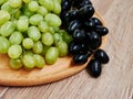 Healthy fruits. Red and green wine grapes on wooden background, dark and green organic wine grapes Royalty Free Stock Photo