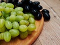 Healthy fruits. Red and green wine grapes on wooden background, dark and green organic wine grapes Royalty Free Stock Photo