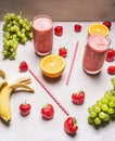 Healthy fruits smoothies with colorful ingredients on white wooden background, top view, place text. Superfoods and healthy li Royalty Free Stock Photo