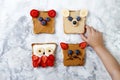 Healthy funny face sandwiches for kids. Animal faces toast with peanut and cashew butter, ricotta, banana, strawberry Royalty Free Stock Photo