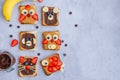 Healthy funny face sandwiches for kids. Animal faces toast with peanut and hazelnat chocolate butter Royalty Free Stock Photo