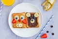 Healthy funny face sandwiches for kids. Animal faces toast with peanut and hazelnat chocolate butter Royalty Free Stock Photo