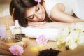 A healthy girl relaxing on the massage table. Before the procedure in the spa. Masseur goes to massage his back. Body care. Skin c Royalty Free Stock Photo