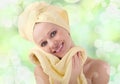 Healthy girl with yellow skin wipes with towel