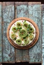 Healthy gluten free, sugar free, no bake dessert. Homemade pie with kiwi roses, berries, mint and cream filling on nutty crust on