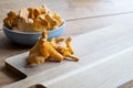 Edible chanterelle mushrooms on rustic wooden cutting board in the kitchen