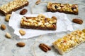 Healthy granola bars with nuts, seeds and dried fruits on the gray texture table, with copy space. Royalty Free Stock Photo