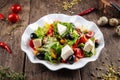 Healthy greek salad with fresh vegetables, cheese and olives in a white plate Royalty Free Stock Photo