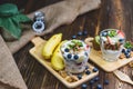 Healthy Greek yogurt with Granola and mixed berries on wooden table and many fruits. Food and dessert concept