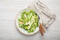 Healthy green avocado salad bowl with boiled eggs, sliced cucumbers, edamame beans, olive oil and herbs on ceramic plate Royalty Free Stock Photo