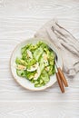 Healthy green avocado salad bowl with boiled eggs, sliced cucumbers, edamame beans, olive oil and herbs on ceramic plate Royalty Free Stock Photo