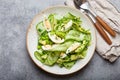 Healthy green avocado salad bowl with boiled eggs, sliced cucumbers, edamame beans, olive oil and herbs on ceramic plate Royalty Free Stock Photo