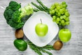 Healthy green food with fresh vegetables on gray wooden table background top view Royalty Free Stock Photo