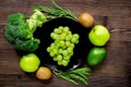 Healthy green food with fresh vegetables on wooden table background top view Royalty Free Stock Photo