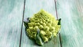 Healthy Green Organic Raw cabbage romanesco. Bunch of fresh green broccoli on a wooden board. top view, place for text Royalty Free Stock Photo