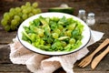 Healthy green salad from avocado, cucumber, grapes, parsley and lettuce with olive oil dressing, balsamic vinegar and grain mustar Royalty Free Stock Photo