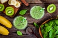 Healthy green smoothie with banana, kiwi, spinach and chia seeds in glass jars Royalty Free Stock Photo