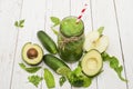 Healthy green smoothie with banana, spinach, avocado and kiwi in a glass bottles on a rustic Royalty Free Stock Photo