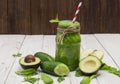 Healthy green smoothie with banana, spinach, avocado and kiwi in a glass bottles on a rustic Royalty Free Stock Photo