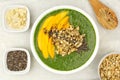 Healthy green smoothie bowl overhead view on granite Royalty Free Stock Photo