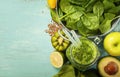 Healthy green smoothie and ingredients on blue background Royalty Free Stock Photo