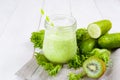 Healthy green smoothie in jar with cucumber, kiwi, salad and spices Royalty Free Stock Photo