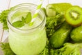 Healthy green smoothie in jar with cucumber, kiwi, salad and spices Royalty Free Stock Photo