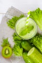 Healthy green smoothie in jar with cucumber, kiwi, salad and spices Royalty Free Stock Photo