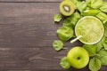 Healthy green smoothie with kiwi, apple on rustic wood background Royalty Free Stock Photo