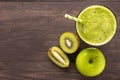 Healthy green smoothie with kiwi, apple on rustic wood background Royalty Free Stock Photo