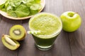 Healthy green smoothie with kiwi, apple on rustic wood background Royalty Free Stock Photo