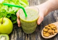 Healthy green smoothie with kiwi, apple on rustic wood background. Royalty Free Stock Photo